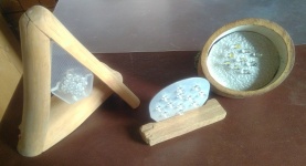 self assembled led lamps from wood, acrylic glass, aluminium and white standard leds. on the left side, a wood triangle made from sanded sticks, inside a rhombus shaped acrylic glass with nine leds, in the middle, a oval aluminium plate with twelve leds fixed to a smal wooden board, on the right, a angled cut bamboo tube with an aluminium disc inside holding nine leds.